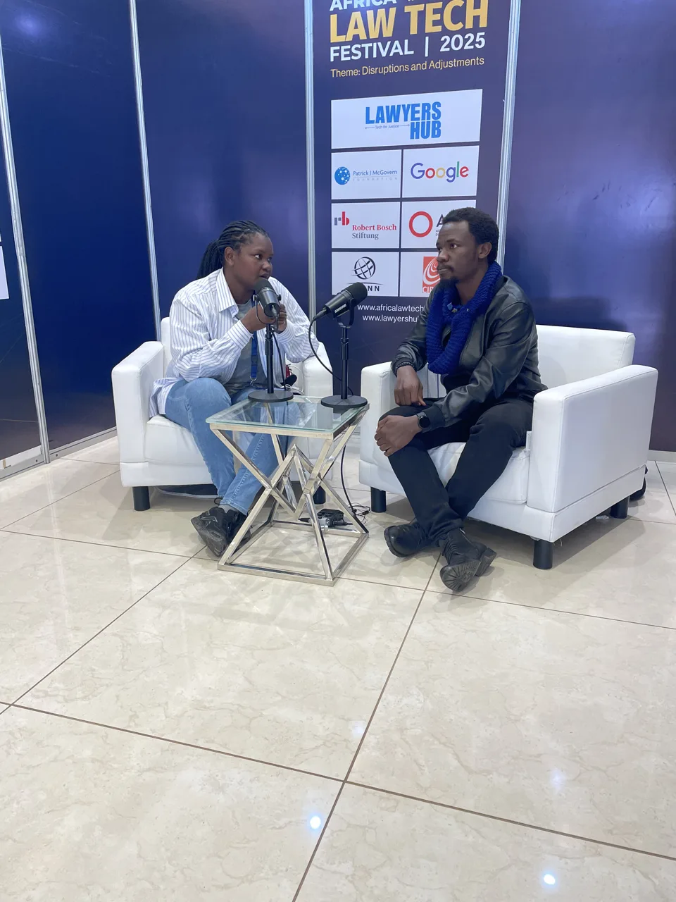 Two participants in conversation at the Africa Law Tech Festival